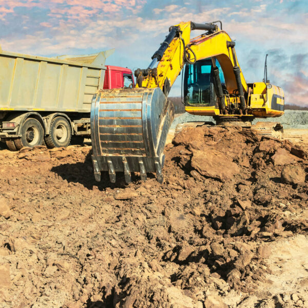 powerful-crawler-excavator-loads-earth-into-dump-truck-against-blue-sky-development-removal-soil-from-construction-site (1)